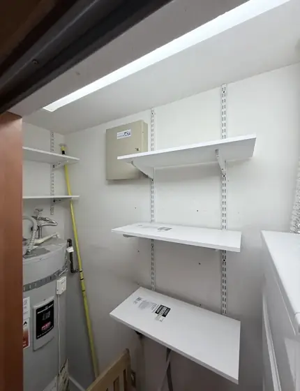 White track shelving in a utility closet